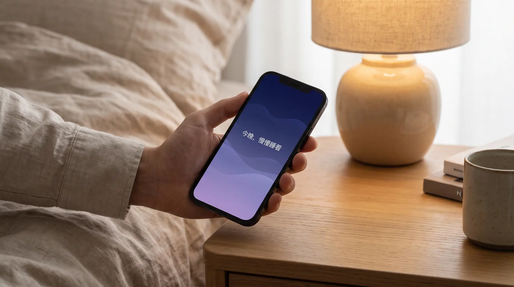 A hand holding a phone showing the Tidal app home screen