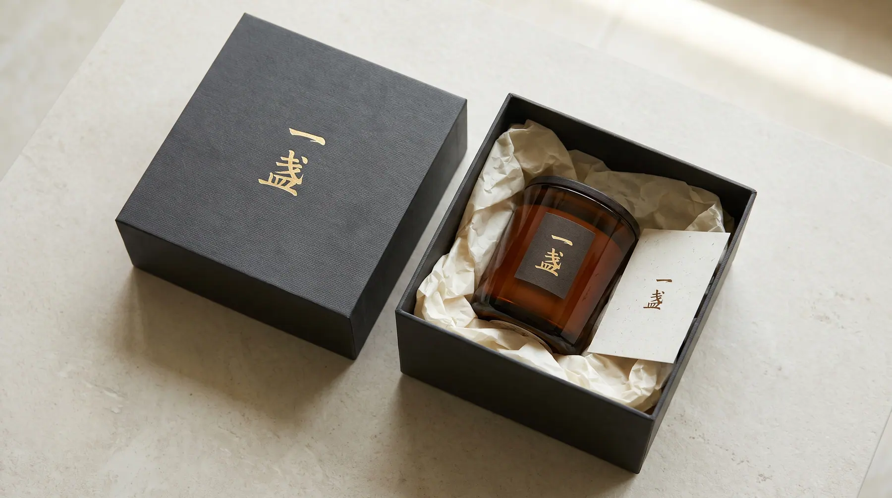 An open One Lamp gift box with an amber candle inside